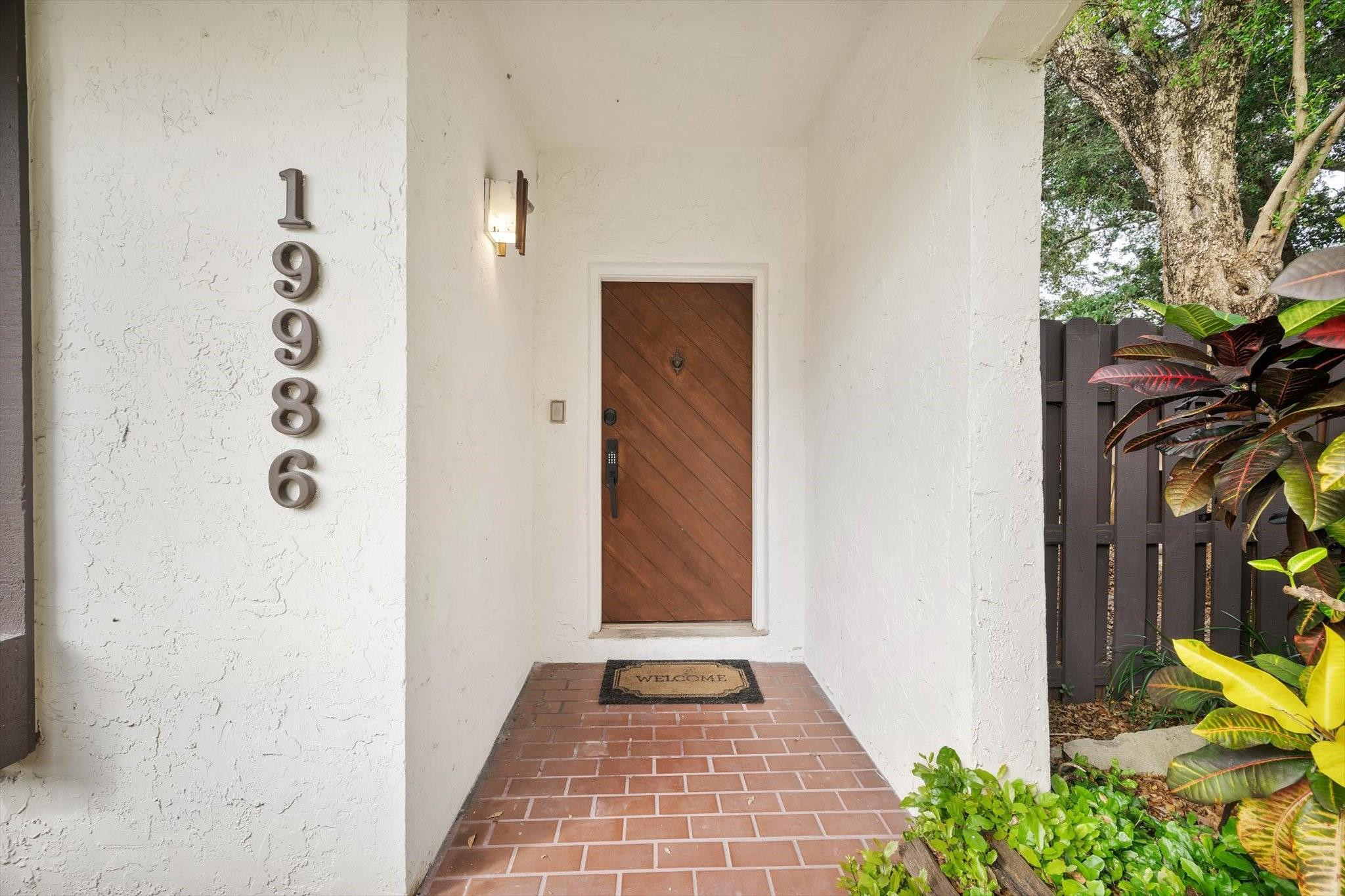 19986 Northeast 5th Court, Unit 4D Miami, FL 33179 - Photo 36 of 46 a view of a hallway with wooden door