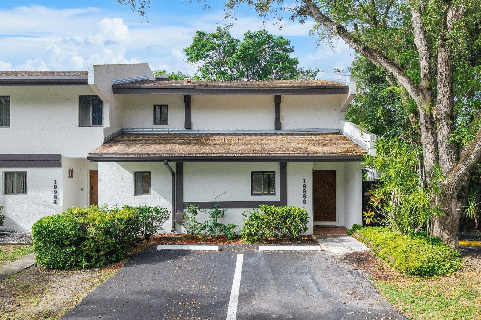 19986 Northeast 5th Court, Unit 4D Miami, FL 33179 - Photo 37 of 46 a front view of a house with garden