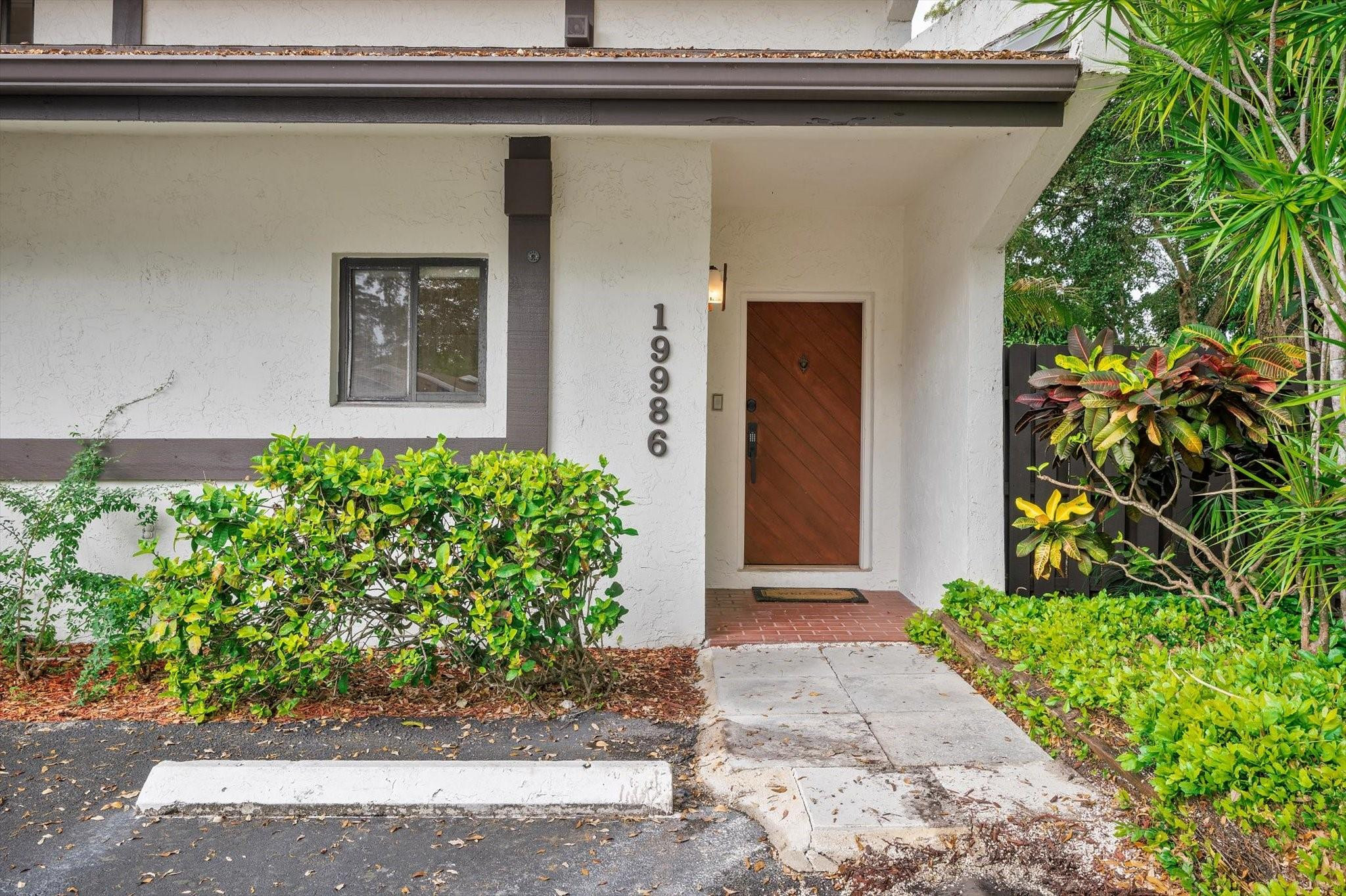 19986 Northeast 5th Court, Unit 4D Miami, FL 33179 - Photo 38 of 46 a front view of a house with garden