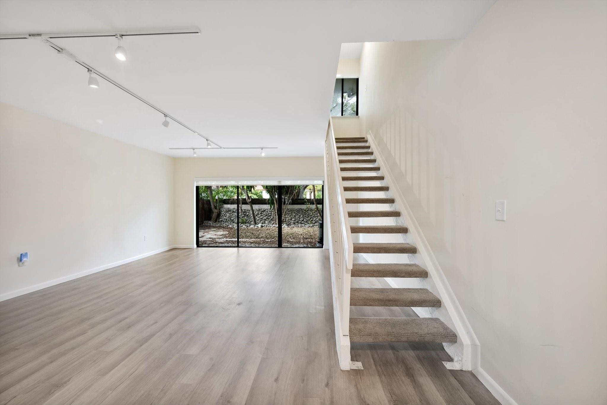 19986 Northeast 5th Court, Unit 4D Miami, FL 33179 - Photo 4 of 46 a view of entryway and hall with wooden floor