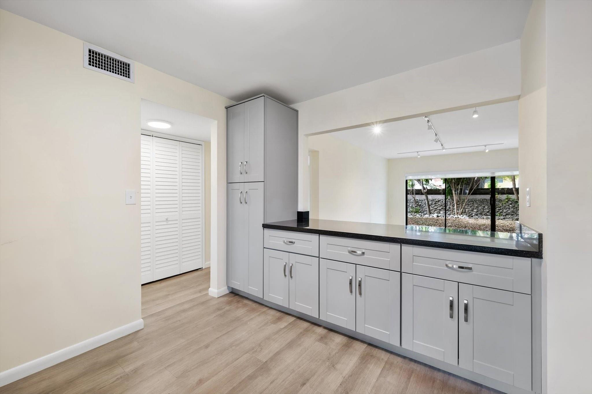 19986 Northeast 5th Court, Unit 4D Miami, FL 33179 - Photo 7 of 46 a kitchen with granite countertop white cabinets and a sink