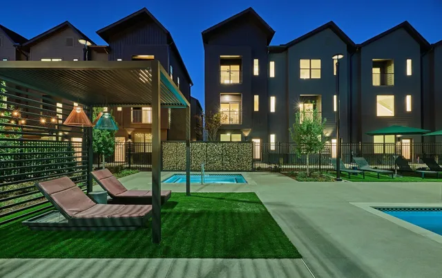 a view of a house with backyard porch and sitting area
