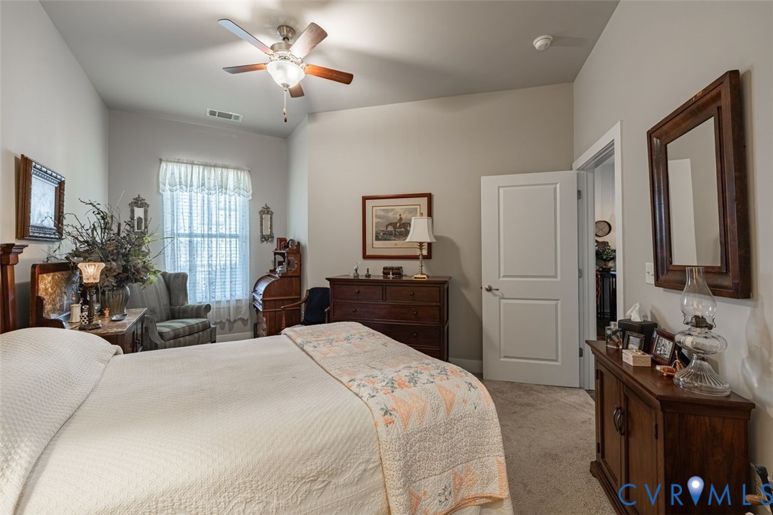 10521 Stony Bluff Drive, Unit 402 Ashland, VA 23005 - Photo 19 of 45 Bedroom with light colored carpet and ceiling fan