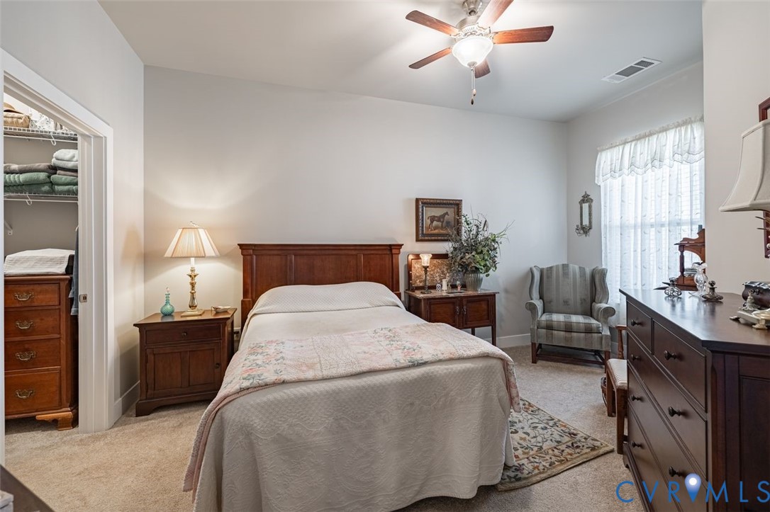 10521 Stony Bluff Drive, Unit 402 Ashland, VA 23005 - Photo 21 of 45 Bedroom with light carpet, a ceiling fan, and a sp