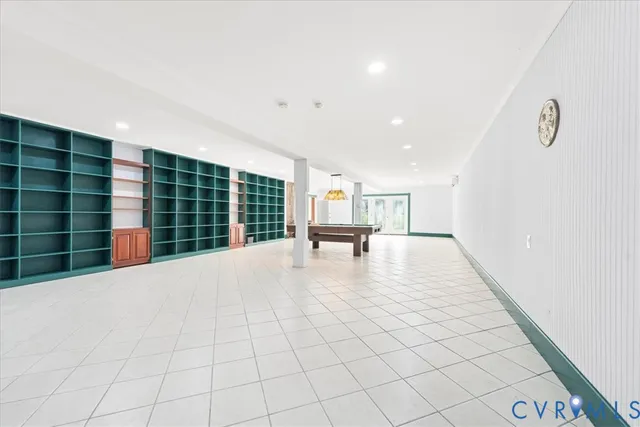 a view of empty room with wooden floor and cabinet