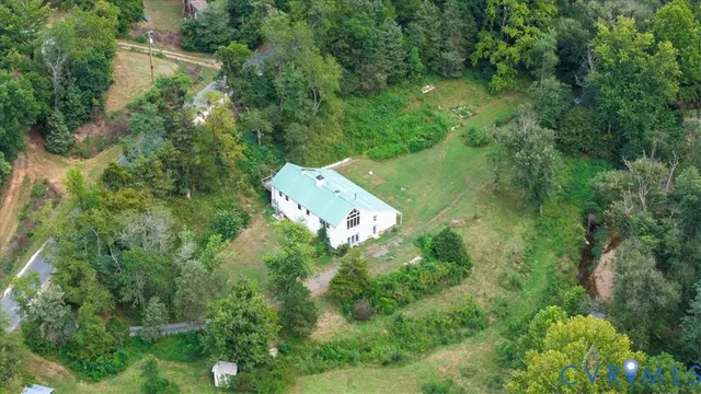 an aerial view of a house with a yard