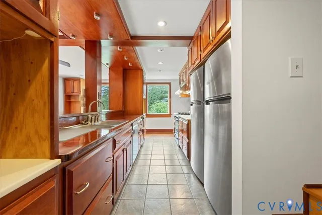 a kitchen with stainless steel appliances granite countertop a stove and a sink