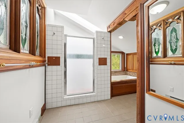a bathroom with a tub and shower