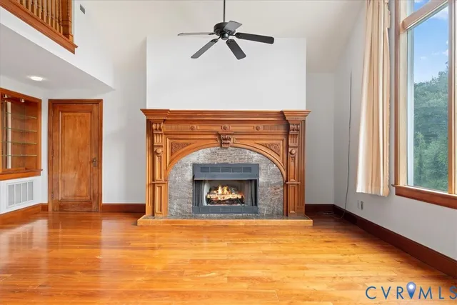 a view of a livingroom with a fireplace and window