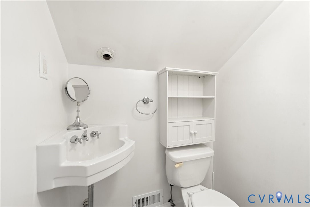 1208 Manteo Road Buckingham, VA 23921 - Photo 42 of 44 a bathroom with a toilet a sink and mirror