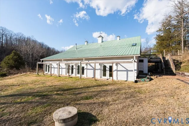 a front view of house with yard and trees around