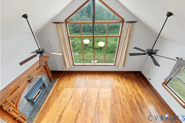 a view of a room with wooden floor and windows