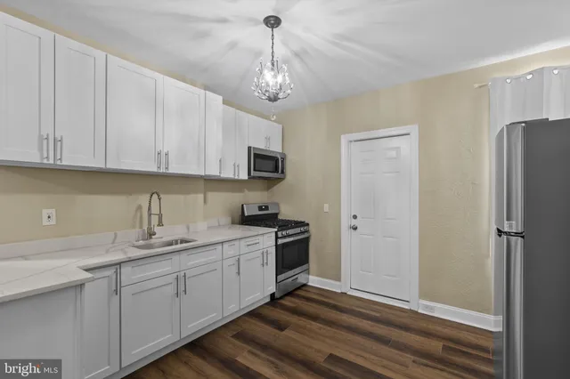 a kitchen with stainless steel appliances granite countertop a refrigerator sink and cabinets