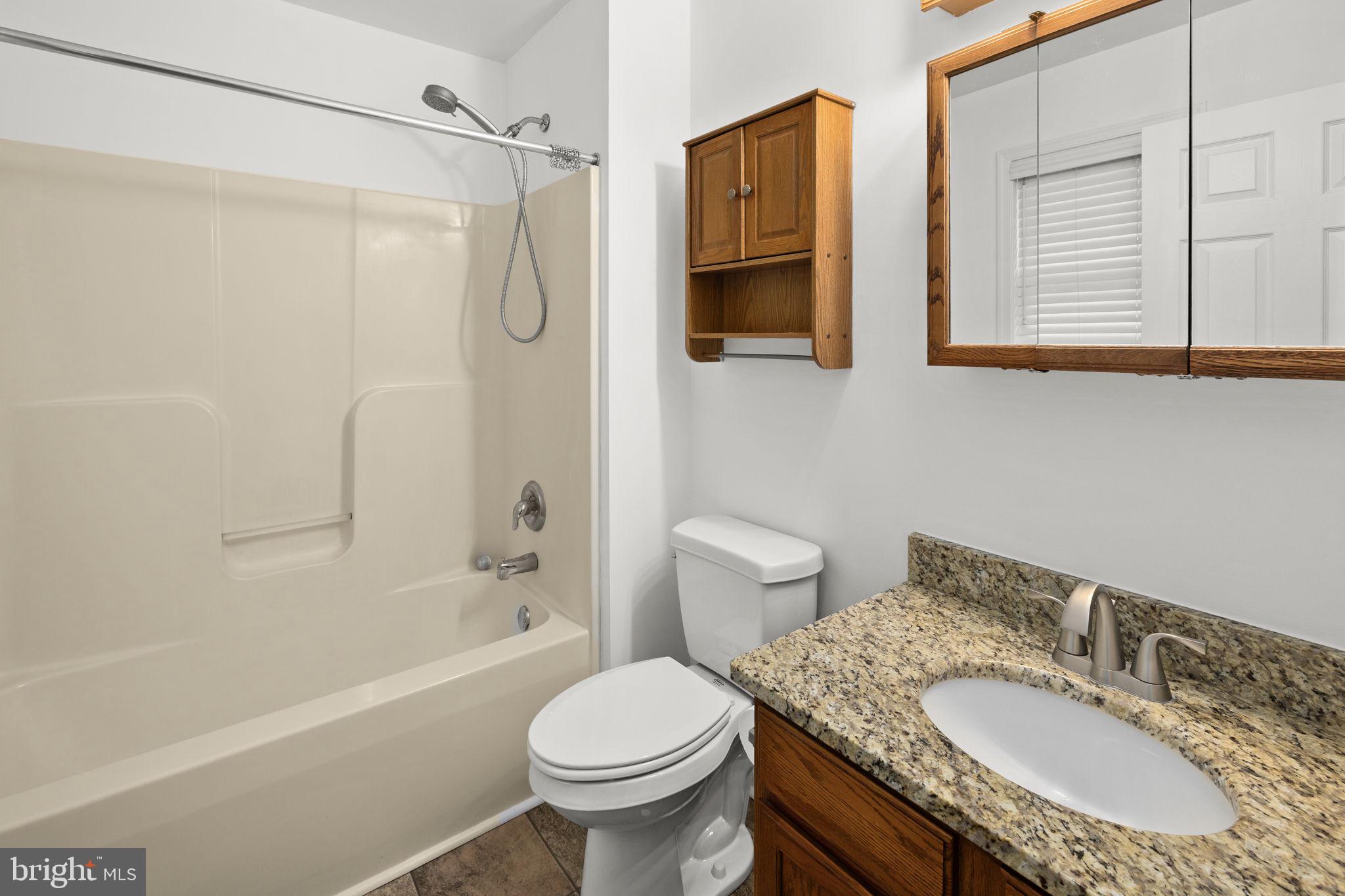 25281 Boling Lane Rhoadesville, VA 22542 - Photo 12 of 41 a bathroom with a granite countertop sink toilet and shower