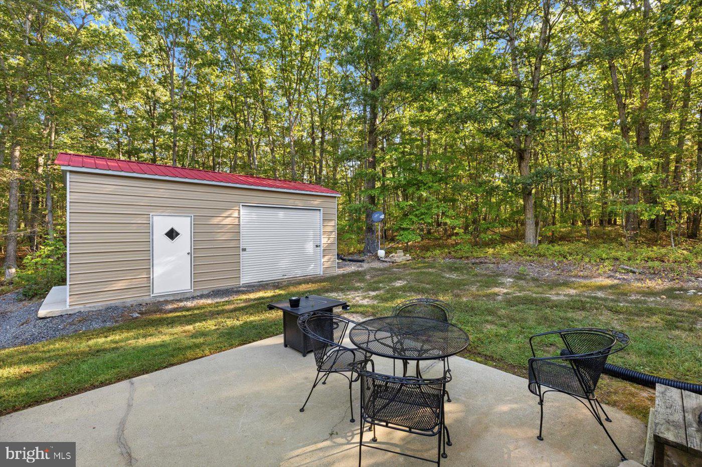 25281 Boling Lane Rhoadesville, VA 22542 - Photo 20 of 41 a backyard of a house with table and chairs