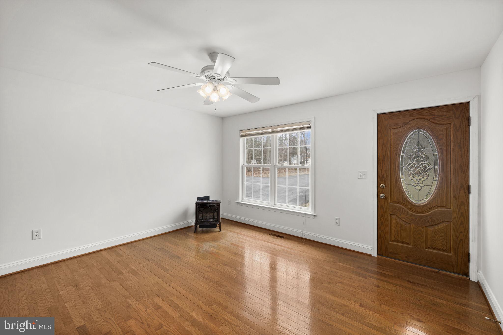 25281 Boling Lane Rhoadesville, VA 22542 - Photo 23 of 41 an empty room with wooden floor fan and windows