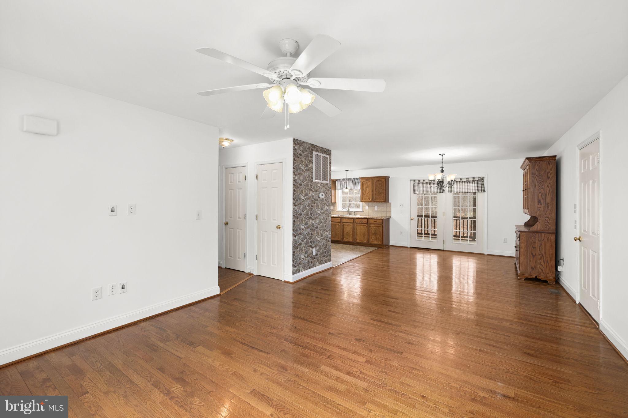 25281 Boling Lane Rhoadesville, VA 22542 - Photo 25 of 41 a view of a livingroom with wooden floor and a ceiling fan