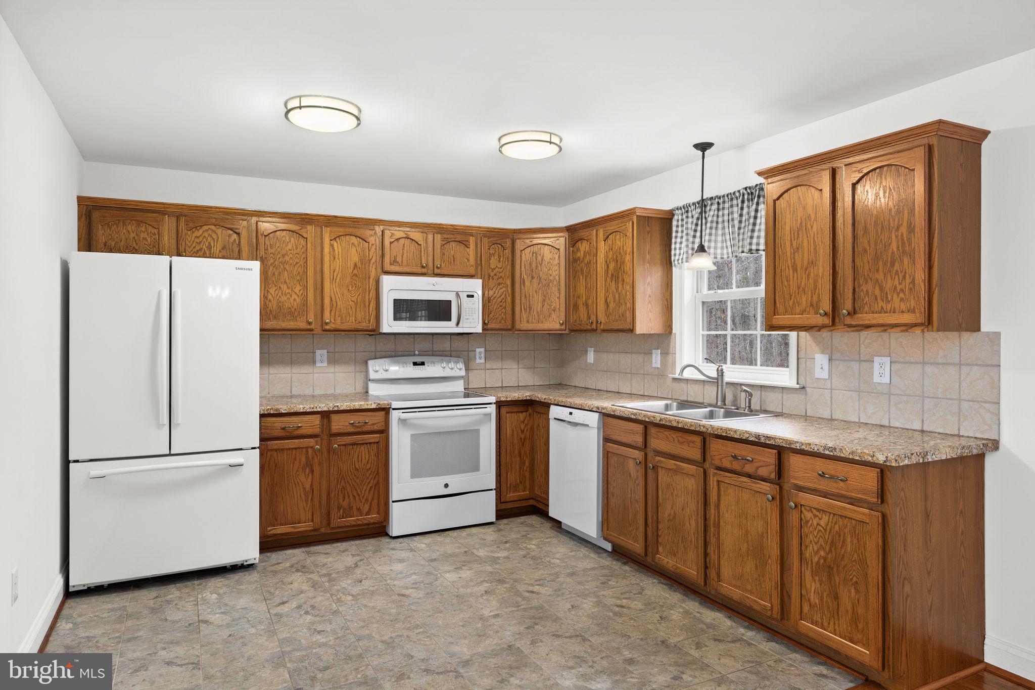 25281 Boling Lane Rhoadesville, VA 22542 - Photo 27 of 41 a kitchen with stainless steel appliances granite countertop a refrigerator sink and stove