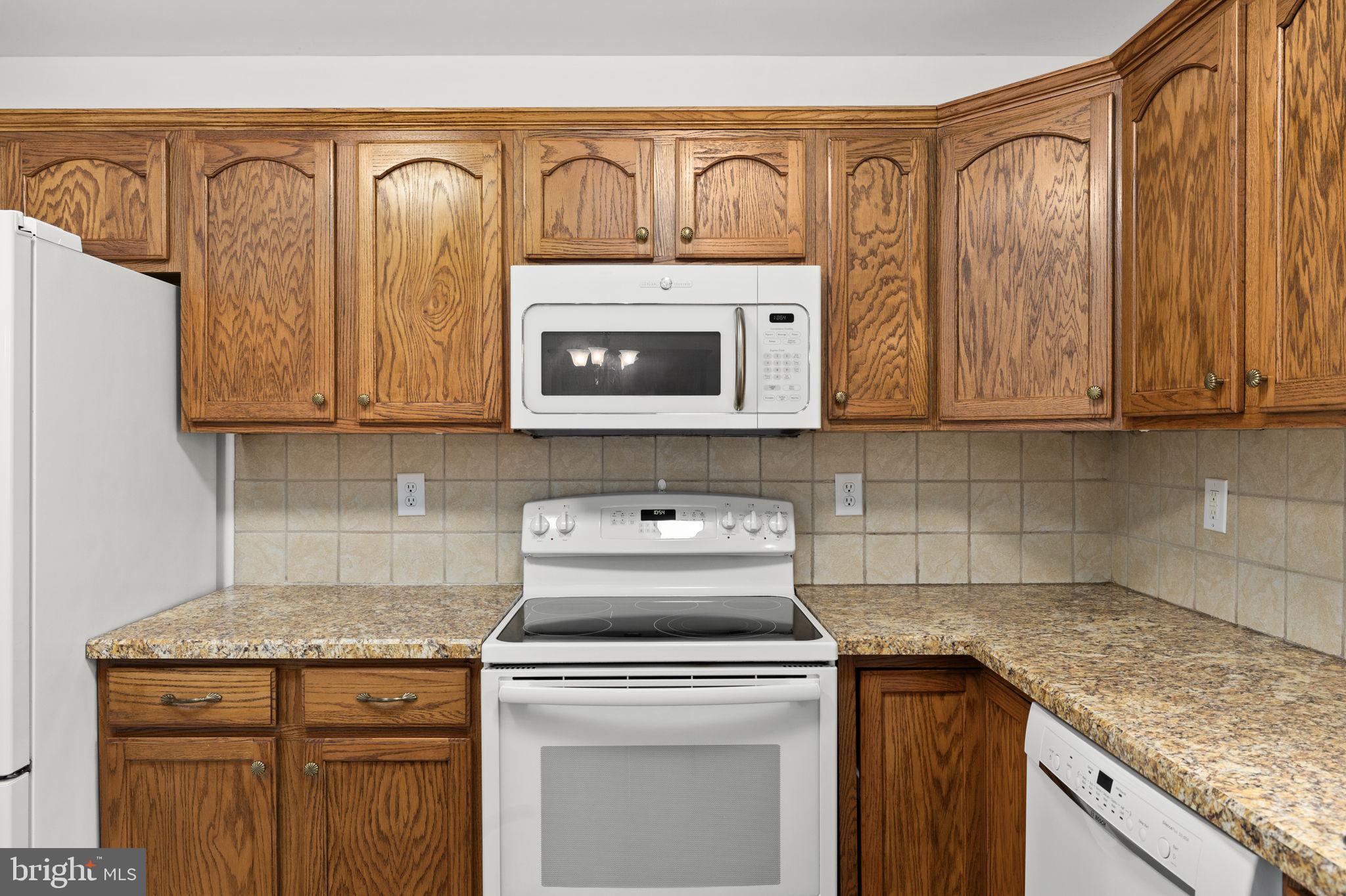25281 Boling Lane Rhoadesville, VA 22542 - Photo 28 of 41 a kitchen with stainless steel appliances granite countertop a sink a stove a microwave and cabinets