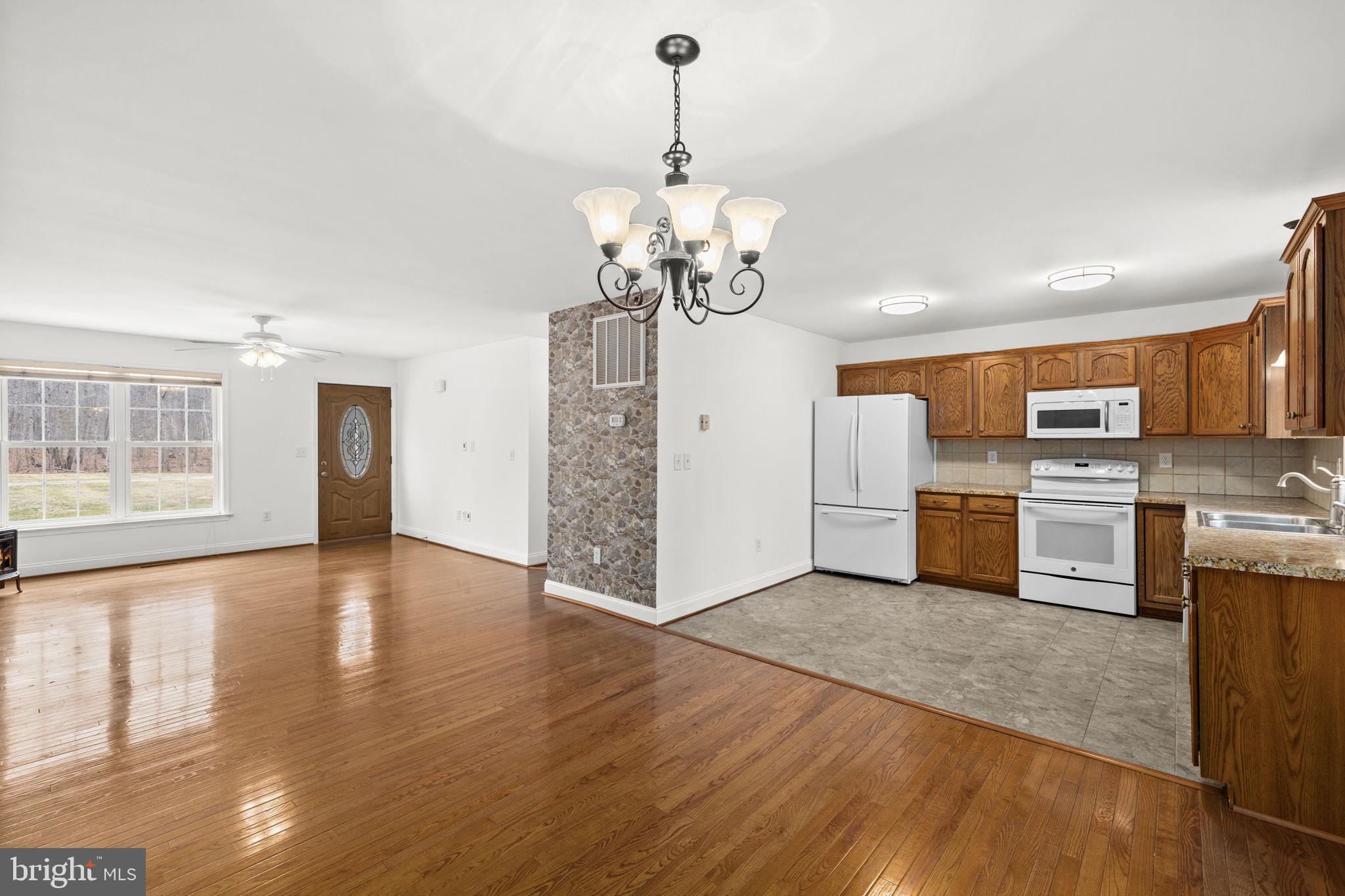 25281 Boling Lane Rhoadesville, VA 22542 - Photo 30 of 41 a view of a kitchen with a sink a refrigerator and a stove