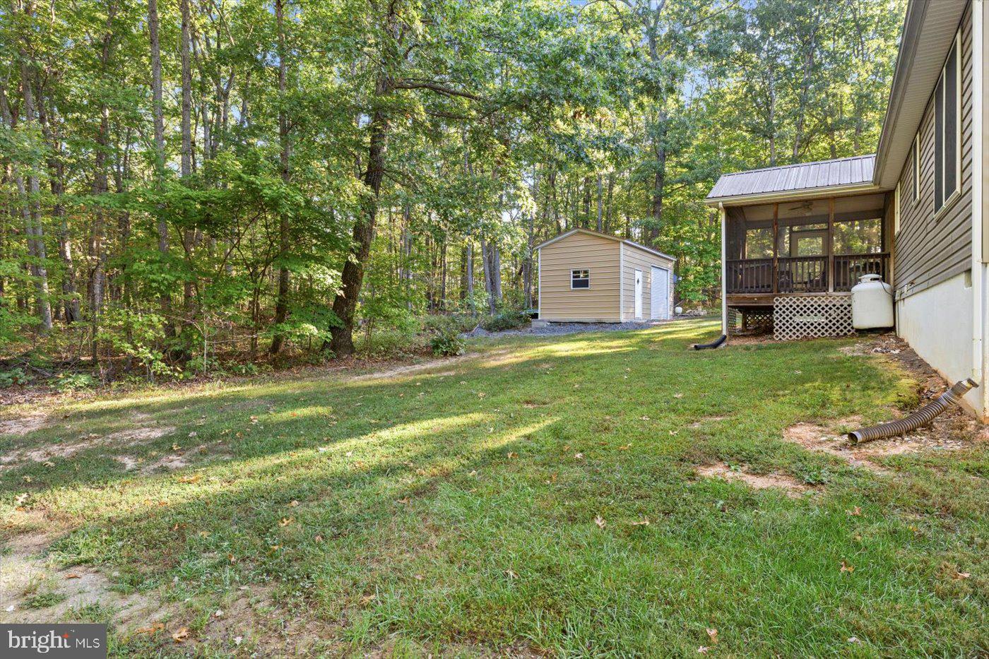 25281 Boling Lane Rhoadesville, VA 22542 - Photo 33 of 41 a view of a house with a big yard and large tree