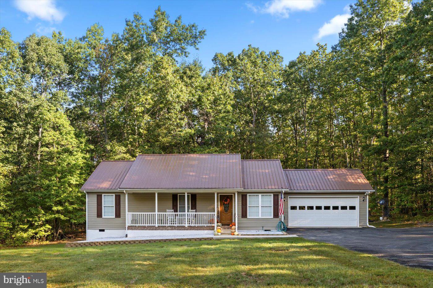 25281 Boling Lane Rhoadesville, VA 22542 - Photo 37 of 41 a front view of a house with a garden and trees