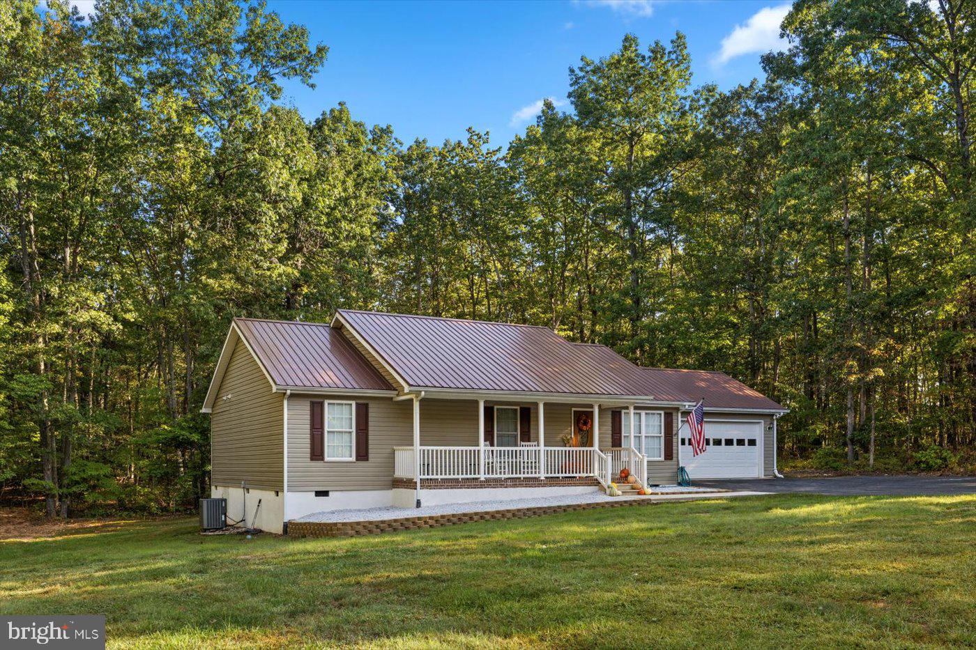 25281 Boling Lane Rhoadesville, VA 22542 - Photo 38 of 41 a front view of a house with a garden and trees