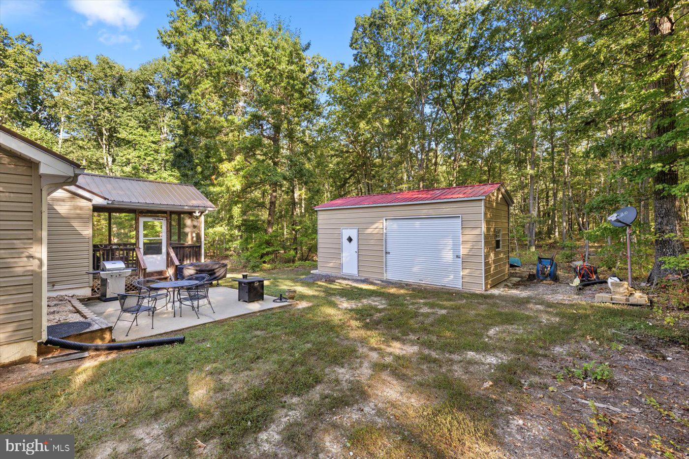 25281 Boling Lane Rhoadesville, VA 22542 - Photo 40 of 41 a view of a patio with table and chairs under an umbrella