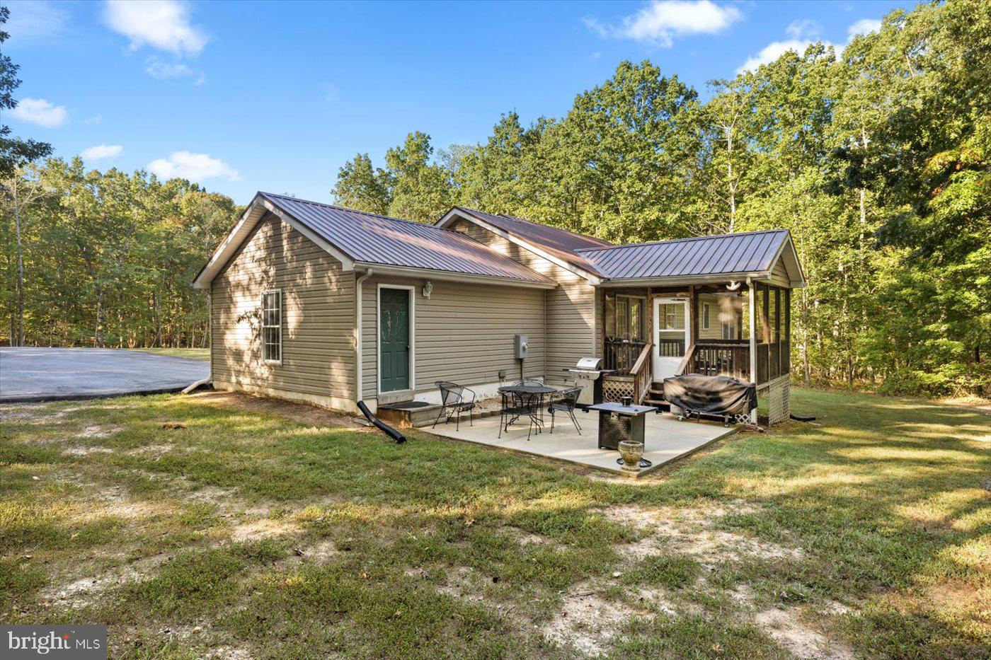 25281 Boling Lane Rhoadesville, VA 22542 - Photo 41 of 41 a view of a house with backyard porch and sitting area