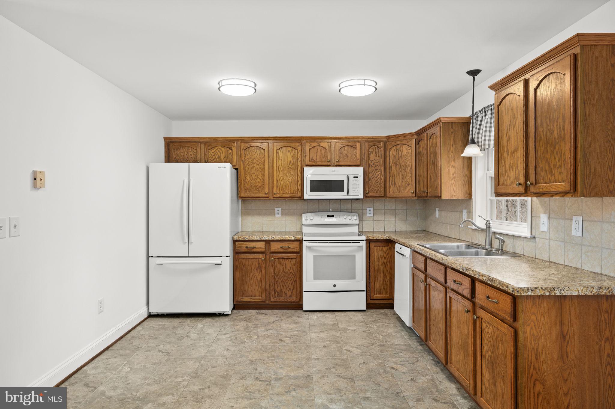 25281 Boling Lane Rhoadesville, VA 22542 - Photo 7 of 41 a kitchen with stainless steel appliances granite countertop a stove a sink dishwasher a refrigerator and a microwave oven