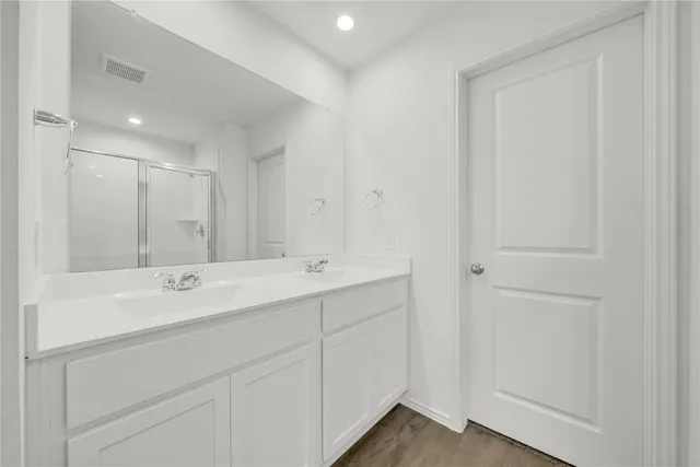 a bathroom with a glass shower door