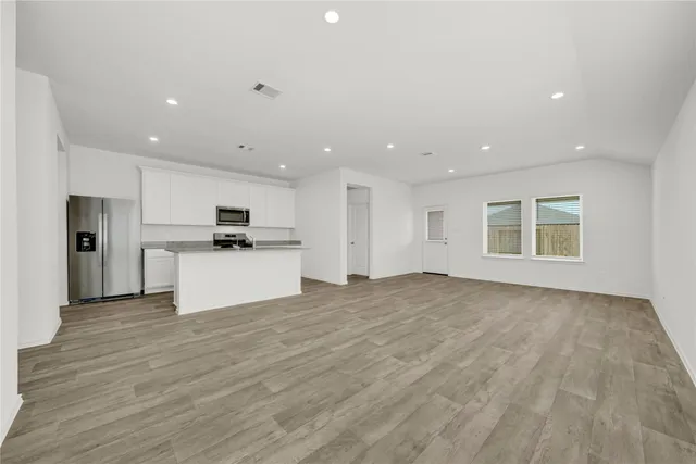 a view of a kitchen with a sink and a refrigerator
