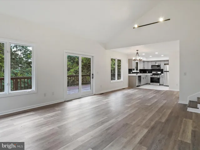 a view of kitchen with furniture and wooden floor