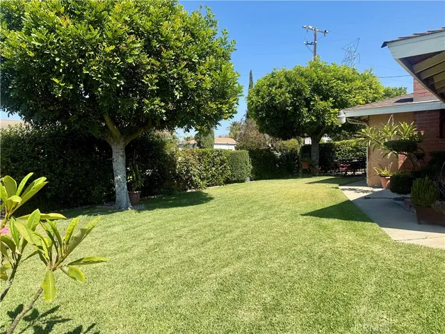 a view of swimming pool with a patio and a yard