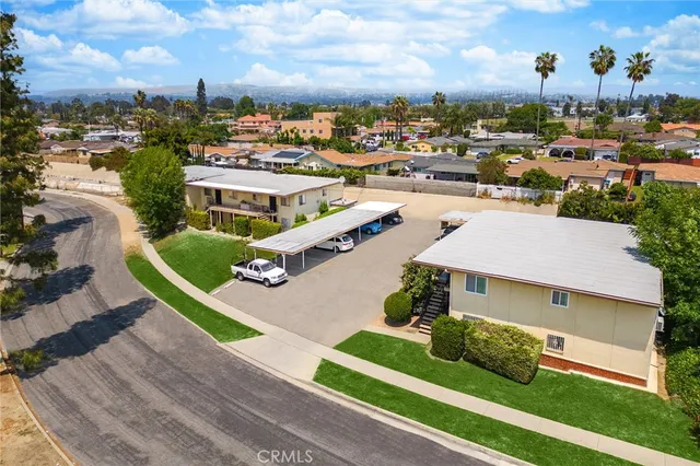 an aerial view of a house with garden space and street view