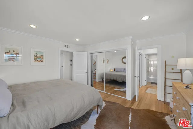 a bedroom with a bed and a walk in closet