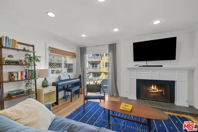a living room with furniture fireplace and flat screen tv