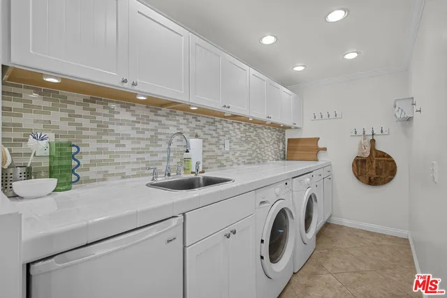 a kitchen with a sink and a stove top oven