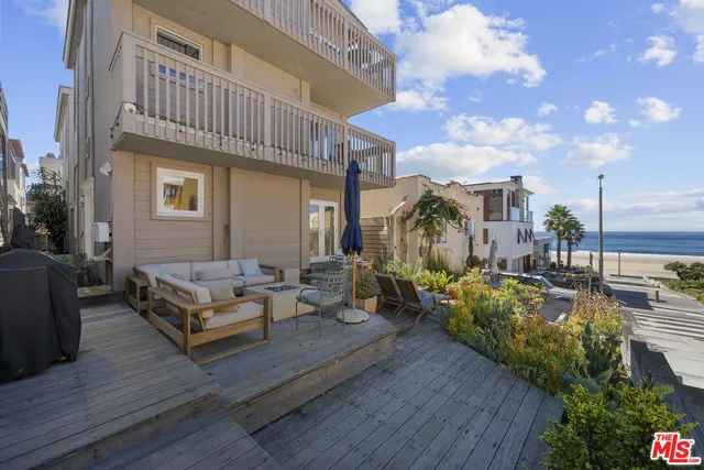 a view of a patio with couches and potted plants