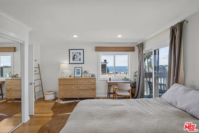 a view of a bedroom with workspace and bedroom