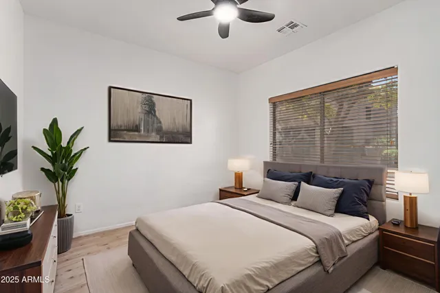 a bedroom with bed and a potted plant