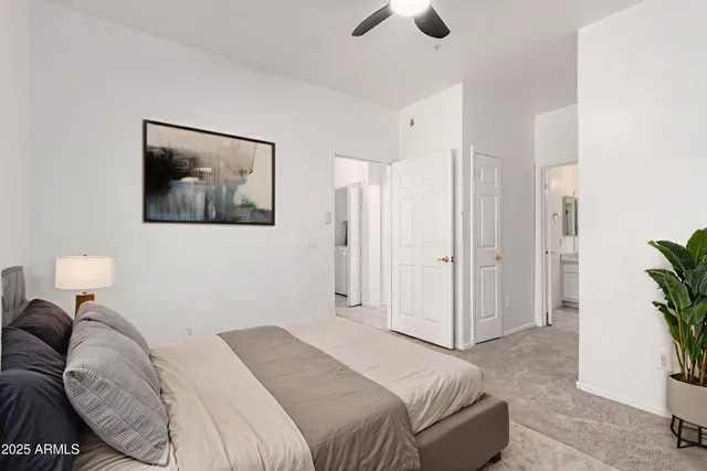 a bedroom with a bed and a potted plant