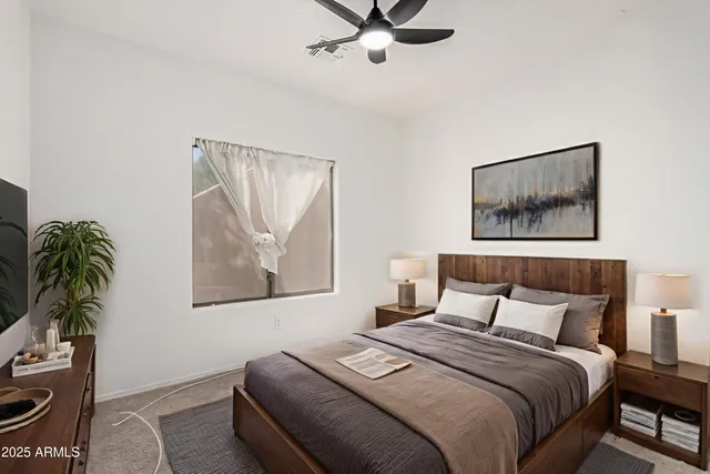 a bedroom with a bed and a painting on the wall