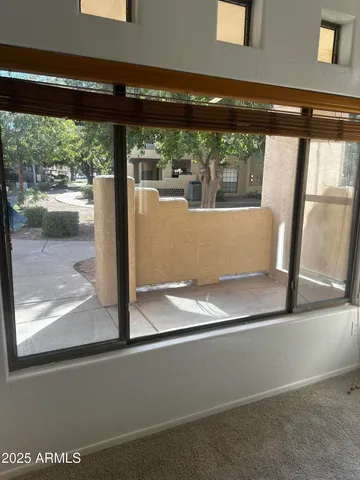 a view of a floor to ceiling window and an outdoor view