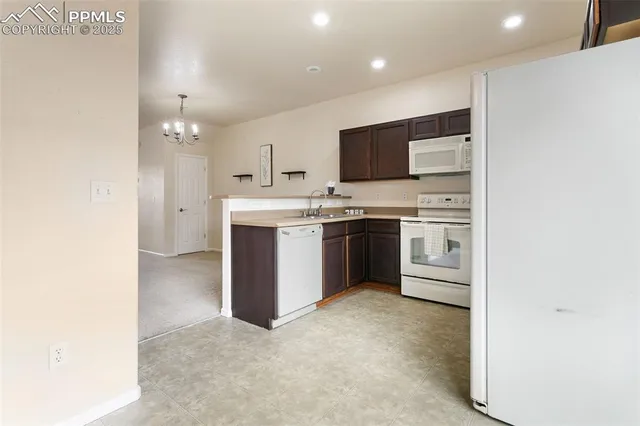 a view of a kitchen with a sink and stainless steel appliances