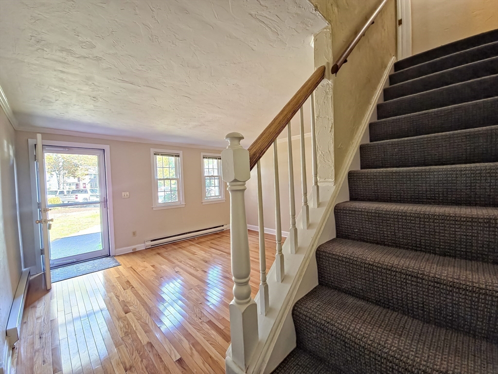 300 Falmouth Road, Unit 18E Mashpee, MA 02649 - Photo 14 of 33 a view of entryway and hall with wooden floor