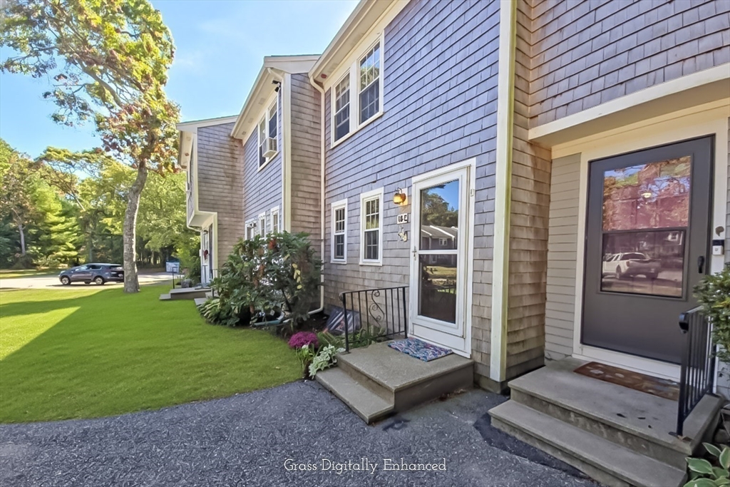 300 Falmouth Road, Unit 18E Mashpee, MA 02649 - Photo 24 of 33 a view of a house with backyard and a garden