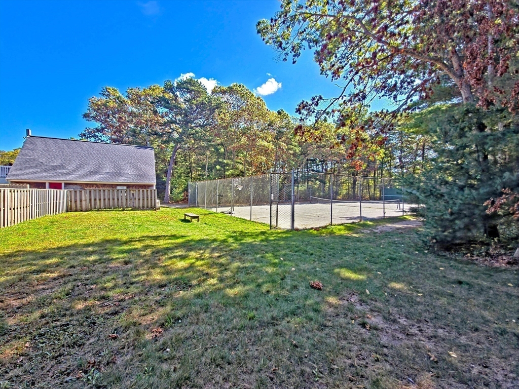 300 Falmouth Road, Unit 18E Mashpee, MA 02649 - Photo 30 of 33 a view of a house with a backyard