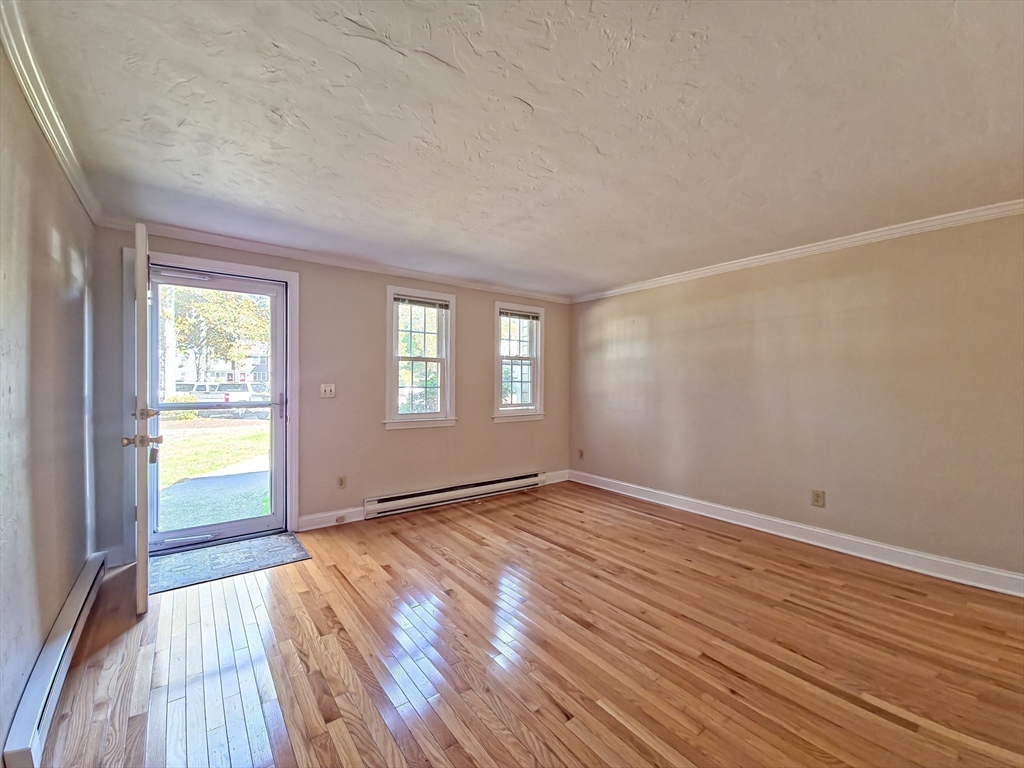 300 Falmouth Road, Unit 18E Mashpee, MA 02649 - Photo 3 of 33 wooden floor in an empty room with a window