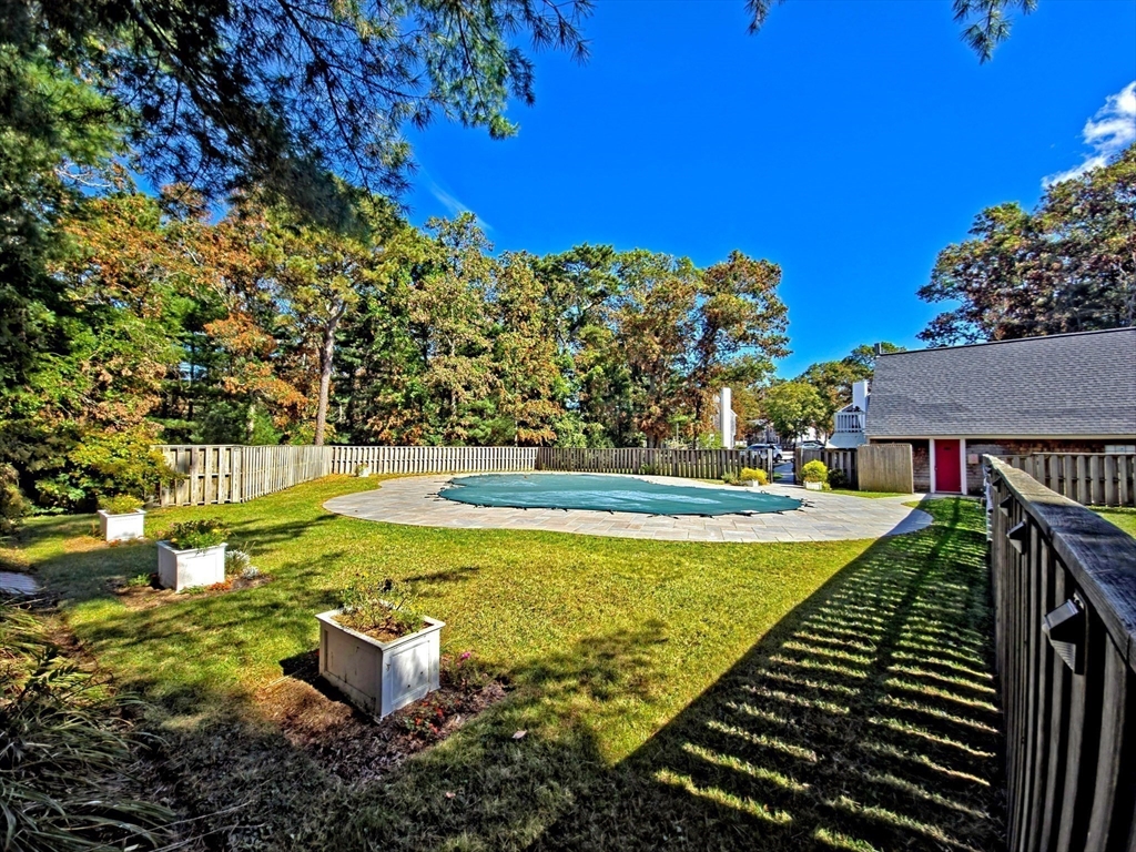 300 Falmouth Road, Unit 18E Mashpee, MA 02649 - Photo 31 of 33 a view of a swimming pool with a yard